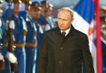 Russia EXITS Human Rights Agreement A man in dark coat at a military event.