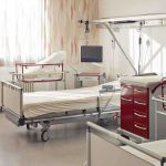 A hospital room featuring empty patient beds and medical equipment