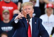 Dictator Taken Alive by U.S. Forces Man in suit pointing, speaking at a rally.