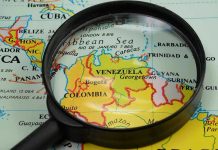 Cuba’s Economy Just Lost Its Biggest Crutch Magnifying glass focusing on Venezuela and Colombia on map.