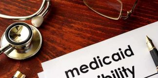 Stethoscope pen document about Medicaid eligibility on table