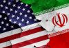 Bunker-Buster Blitz Hits Iran Coast Cracked American and Iranian flags on a wall.