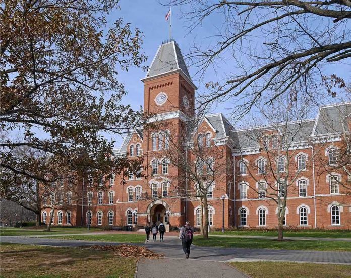 Historic university building with students walking in front during autumn