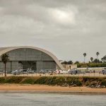 Cuba’s Alleged Drone Threat: Fact or Fiction? Aircraft hangar with helicopters near the beach.