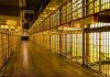 Terrorist MASTERMINDS Conditional Freedom–Outrage Erupts Empty hallway between rows of prison cells.