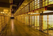 Terrorist MASTERMINDS Conditional Freedom–Outrage Erupts Empty hallway between rows of prison cells.