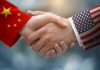 Taiwan Tensions: Trump Puts US-China Ties on Edge Chinese and American flag sleeves shaking hands.
