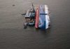 Shock Attack: Odesa in Flames! Capsized ship with cranes and tugboats around it.