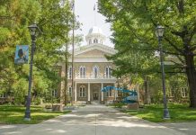 Artists Bolt, Trump Escalates Culture War Historic stone building surrounded by trees and lampposts.
