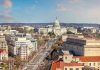 AOC Dismisses White House Dream: Bigger Plans? Washington, D.C. skyline with Capitol Building in background.