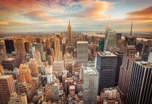 New York City skyline at sunset with tall buildings.