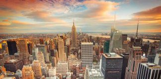 Manhattan Rent Hits Unbelievable $5,000 Mark! New York City skyline at sunset with tall buildings.