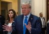 Trump’s Game-Changer: LA Mayor Race Shocker? Man speaking with hands raised, woman and security behind.