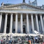 Musk’s Legal Blunder Exposed: Clock Out! Courthouse facade with media crews setting up outside.