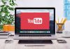 Covert Propaganda Scheme: US Influencers Unwittingly Paid? YouTube logo on a laptop screen on desk.