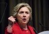 Why Clinton’s Legacy Still Fuels Female President Debate Person speaking passionately at a podium, wearing red jacket.