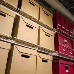 Trump’s Law-and-Order Strategy: Iran As the New Enemy Shelves filled with brown and red storage boxes for organizing documents