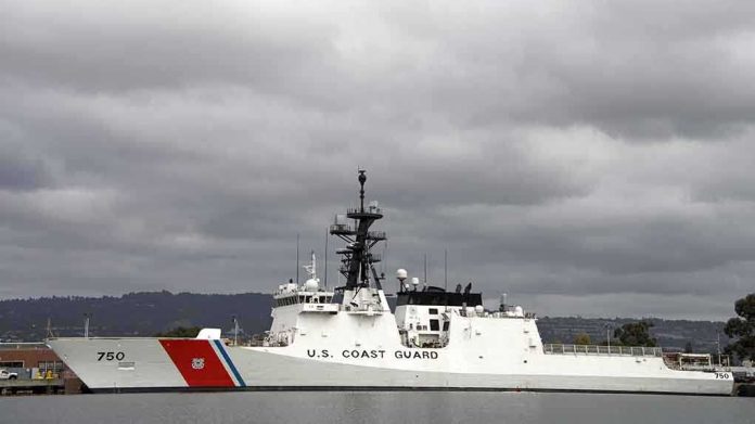 shutterstock_229880047-1 A U.S. Coast Guard ship docked under cloudy skies