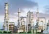 America’s Oil Cushion Vanishes Fast Industrial plant with metal towers and pipes.