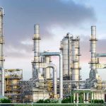 America’s Oil Cushion Vanishes Fast Industrial plant with metal towers and pipes.
