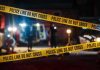 Festival Chaos: Gunman Still Loose Yellow police tape in front of crime scene.