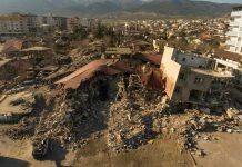 Iran School Blast Has U.S. Fingerprints All Over It Cityscape with collapsed buildings and rubble after earthquake