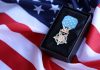 A military medal displayed on a black box with an American flag background