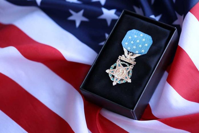 shutterstock_2514301307 A military medal displayed on a black box with an American flag background