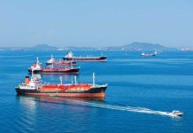 Several cargo ships navigating in a calm ocean