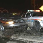 When Running From Police Becomes Murder A damaged car and a police vehicle involved in a nighttime accident