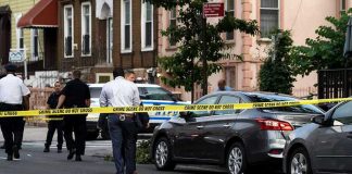 Outrage In NYC: Child Beaten, Motive Debated Police and crime scene tape on city street.