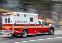 Summer Fun, Deadly Silence Red and white ambulance driving on street.