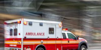 Summer Fun, Deadly Silence Red and white ambulance driving on street.