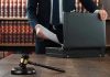 No-Bond Shock: Ex-NFL Star Booked Gavel, lawyer, briefcase, and legal books on the table.