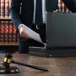 No-Bond Shock: Ex-NFL Star Booked Gavel, lawyer, briefcase, and legal books on the table.