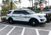 Sheriff SUV parked in a lot near palm trees