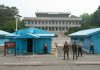 Trump Claims Total Hamas Disarmament Deal Military personnel standing near blue buildings at a border crossing