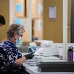 Court Smacks Down USPS Ballot Gatekeeping Election workers wearing masks process mail-in ballots at tables