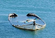 The Fox River Crash: What Prosecutors Say Happened partially sunken boat in calm blue water
