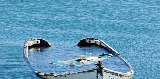 The Fox River Crash: What Prosecutors Say Happened partially sunken boat in calm blue water