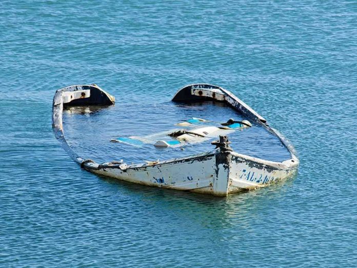 shutterstock_20081782 partially sunken boat in calm blue water