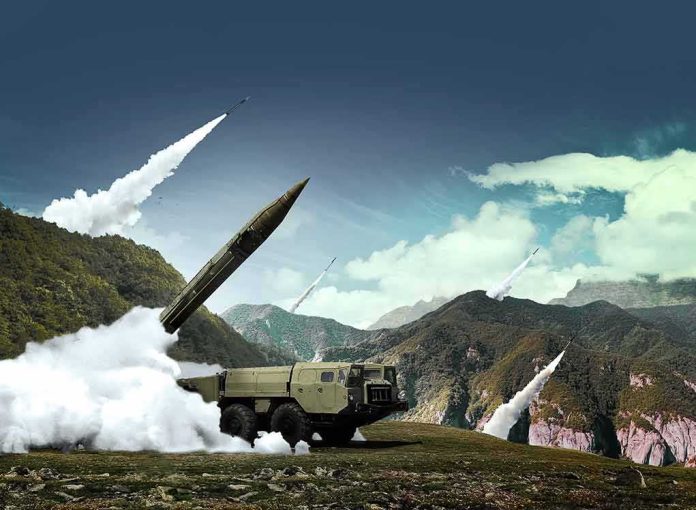 shutterstock_708926692 mobile missile launcher firing in mountain landscape