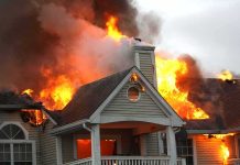 Eight Dead, Gunshots — What Happened Inside? House engulfed in flames with heavy smoke from the roof