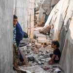 Power Shields Predators In Afghanistan children in a narrow alley with rubble