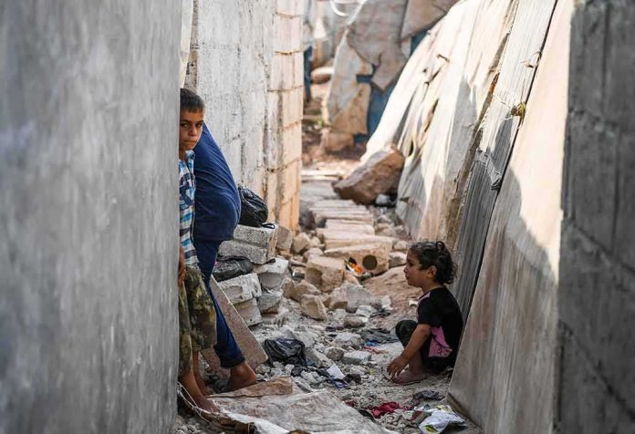 shutterstock_1203193648 children in a narrow alley with rubble
