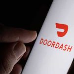 Restaurant Data Demand Gets Torched By Courts Hand holding smartphone showing DoorDash app logo