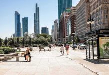 City street with pedestrians and tall modern skyscrapers