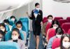American Airlines Drops $1,000 Surprise Airline passengers wearing masks seated on a flight