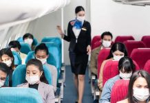 American Airlines Drops $1,000 Surprise Airline passengers wearing masks seated on a flight