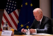How the Autopen Became a Proxy for Presidential Power elderly man at conference table with flags in background